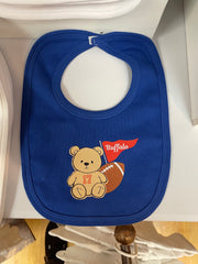 A royal blue baby bib with a custom football-themed graphic featuring a teddy bear, a football, and a red flag that says 'Buffalo'.